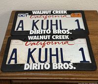 Pair of California vanity license plates with black DIRITO BROS. Walnut Creek frames, one with a 2008 validation sticker.