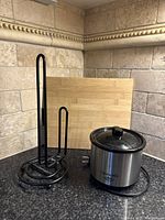 Photo showing paper towel holder, bamboo cutting board, and Crock-Pot Little Dipper mini slow cooker