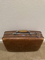 Front view of the vintage brown leather travel case showing the Le Gran logo plaque, chrome latches, and tan handle.