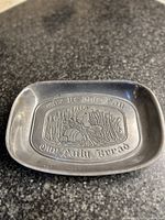 Overhead photo showing the full metal tray and embossed design