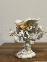 Front side view of the angel figure showing flowing robes, wings, and gentle facial expression.