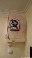 Frontal view of Pabst Blue Ribbon beer advertising light mounted on plastic beer mug-shaped backing.