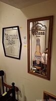 Corona Extra and Corona Light advertising mirrors mounted on a wall, showing their overall size and condition.