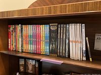 Shelf with multiple DVDs including Monty Python series, Star Wars episodes IV, V, VI, and Seinfeld seasons