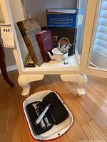 Overview photo showing medical books, glass syringes, mortar and pestle, and enameled tray with Propoer medical scope kit inside tray.