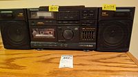 Front view of the Panasonic RX-DS620 boombox with attached speakers, showing cassette decks, buttons, and labels.