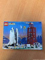 Front cover of the 1995 Lego System manual displaying a space shuttle launch pad with the shuttle and crane under a moonlit sky.
