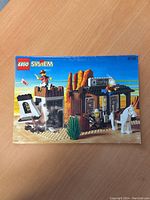 Front cover photo of 1996 Lego System instruction manual #6755 featuring Sheriff Western set with sheriff figure, horse, jail tower, and desert background.