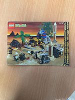 Front cover of the Lego manual showing desert-themed Lego set #5978 with explorers, pyramid, sphinx, rocket, and palm trees under sunset background.
