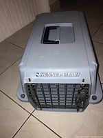 Front view of the Kennel Cab II pet carrier showing metal door with latch and brand name embossed above door.