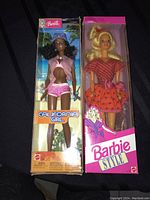 Both Barbie dolls in original boxes side by side showing packaging and dolls.