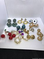 Full view of all 12 pairs of costume earrings showing variety of colours and styles.