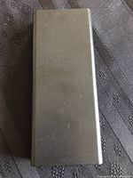 Closed black Monticello pen case with some light surface scratches.