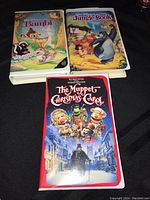 Photo showing three VHS movies: Walt Disney's Bambi, The Jungle Book, and The Muppet Christmas Carol.