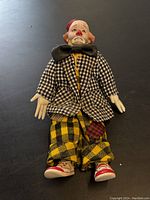 Front view of the clown doll showing detailed clothing and face
