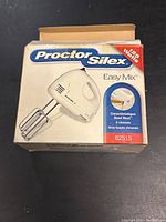 Front view of Proctor Silex Easy Mix hand mixer box showing brand, model, power rating and key features.