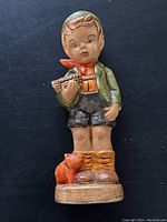 Full view of vintage boy figurine standing with a small cat at his feet