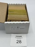 Box containing a large number of O-Pee-Chee hockey cards from 1977-1987, showing pack assortment and quantity.