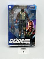 Front view of boxed Roadblock G.I. Joe action figure with visible accessories and character artwork