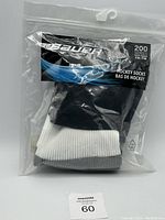 Front view of Bauer hockey socks packaged in original sealed plastic bag, showing branding and product series