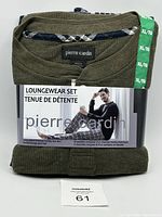 Folded olive green long sleeve thermal Henley top paired with navy blue and gray plaid flannel lounge pants, packaged with a paper band displaying the Pierre Cardin brand and a photo of a man wearing the set.