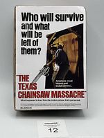 Front of the box packaging showing movie title and tagline with image of Leatherface holding a chainsaw.