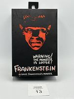 Front of the box showing black background with bright red Frankenstein face and white text