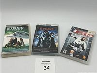 Three PSP UMD videos displayed in a row showing First Descent, Hellboy Directors Cut, and World Tour Soccer.