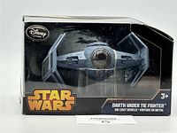 Front view of the diecast Darth Vader TIE Fighter model in original box with visible Star Wars and Disney Store branding.