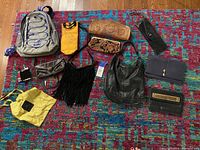 Overview of all bags and pouches displayed on a colorful patterned rug.