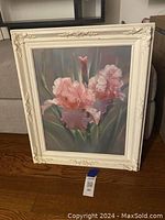 Frontal image showing full framed artwork with pink iris flowers, detailed frame and artwork colors