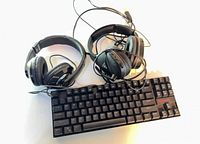 All three items together: two headsets, one keyboard