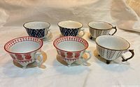 All six JOYYE footed teacups showing three pattern types