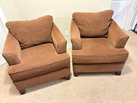 Front view of both brown La-Z-Boy armchairs