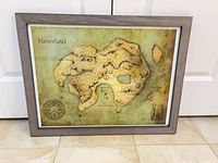 Full framed Neverland map print leaning against door