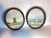 Both oval framed prints side by side
