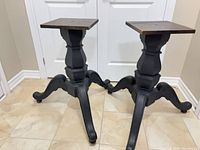 Pair of matte black wooden pedestal bases side by side