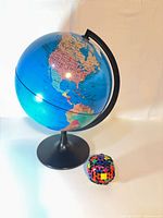 world globe and gear puzzle ball front view