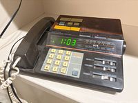 Top view showing handset, keypad, LED clock, radio controls