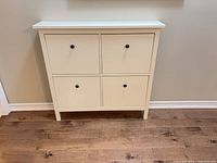 Front view of white IKEA Hemnes cabinet showing four doors and knobs
