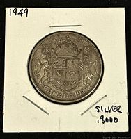 Reverse side of the 1949 Canadian silver 50 cents coin showing the Canadian Coat of Arms, denomination, year and silver content.