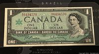 Full front view of 1967 Canadian One Dollar banknote with serial number and design elements visible.