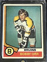 Front of Bobby Orr 1974-75 O-Pee-Chee NHL hockey trading card showing player image in Bruins uniform, team logo, and card number 100.