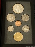 Image of seven Canadian coins from 1994 proof set in a black foam case, front view showing reverse designs including the double dollar with loon.