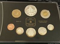 Top view of 2003 Canadian proof coins in black casing showing front sides with Canadian wildlife and denominations.