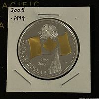 Obverse side showing the Canadian flag with gold plating, fireworks, maple leaf, and the Peace Tower with dates 1965-2005.