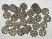 Obverse side of 40 Great Britain one shilling coins showing Queen Elizabeth II portraits.