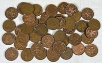Image showing a collection of approximately 40 UK two pence coins laid out on a white surface, displaying the reverse side with the partial shield design and dates ranging from early to late 20th century into the 21st century.