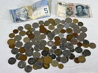 Overview of all coins and paper currency including Canadian and Chinese bills.