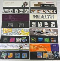 Eight sets of Royal Mail mint collectible stamps in original packaging, each set themed with colorful and detailed stamp designs.